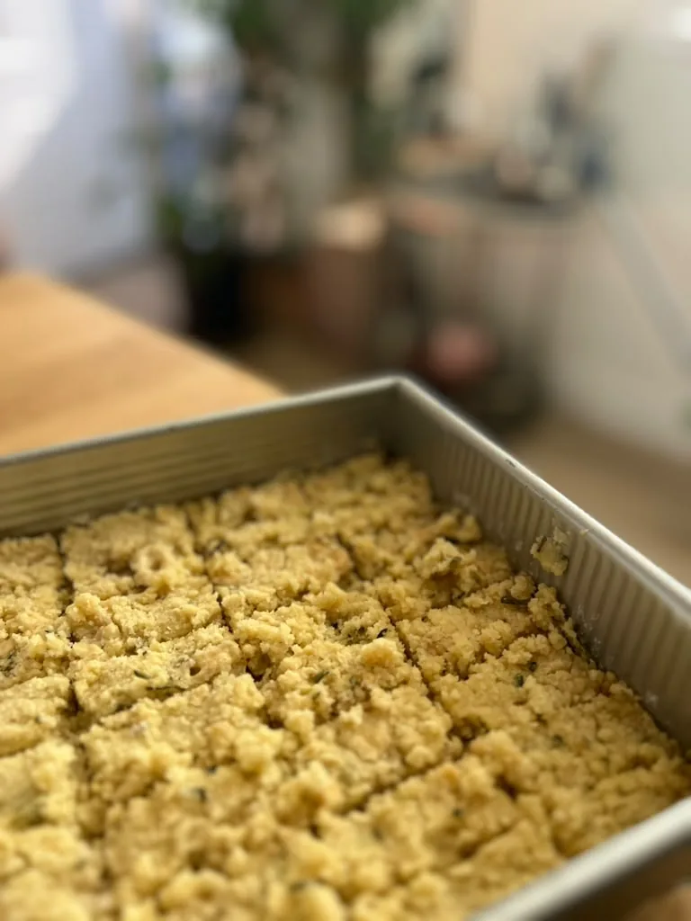 A full tray of crumble-topped bars, scored into squares